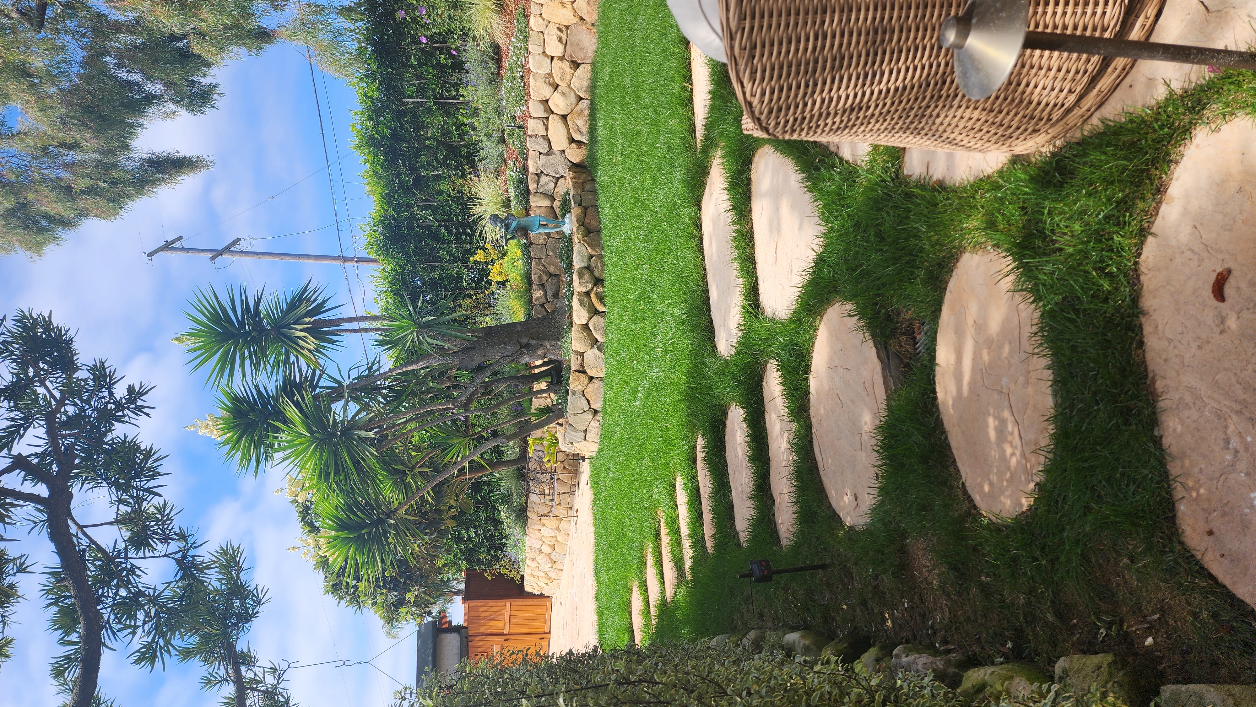 Flagstone stepping stones and boulder retaining walls in a professionally landscaped Santa Barbara backyard.