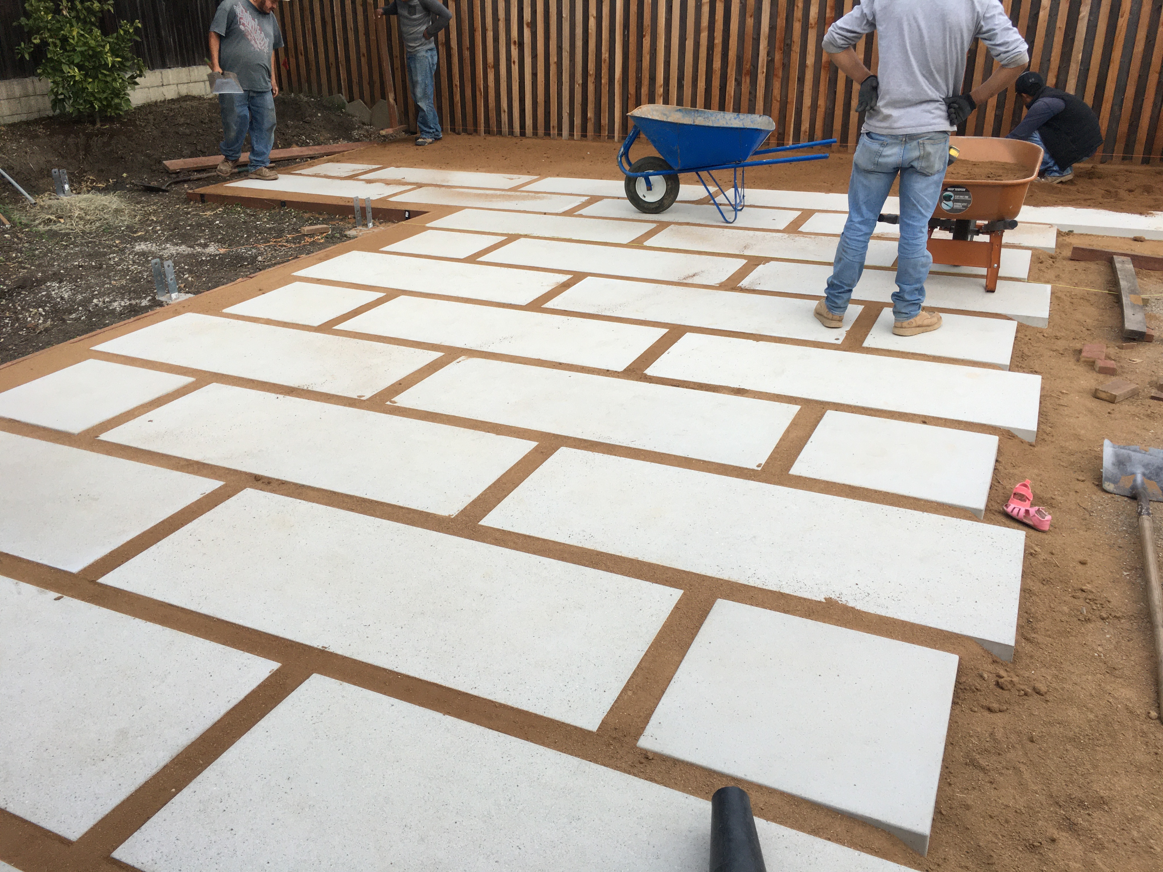 Professional large-format concrete paver patio installation in a Santa Barbara backyard.