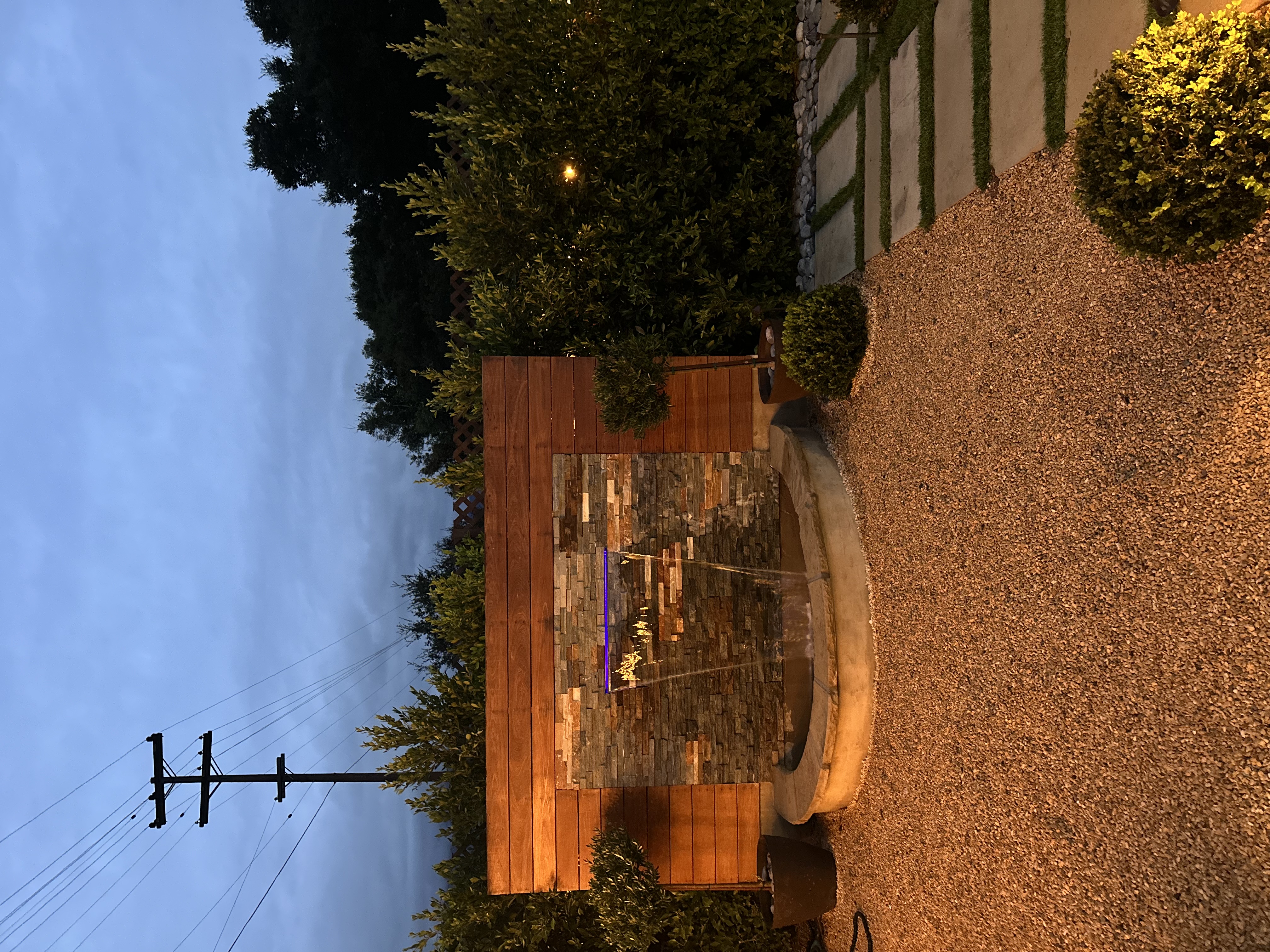 Modern stacked-stone water feature with LED lighting in a Santa Barbara backyard.